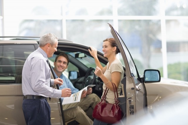 married couple looking at a consumer loans plan for their new car