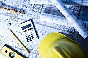 A business owner looking at architectural blueprint and evaluating construction costs