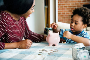 mother teaching her son how to save money