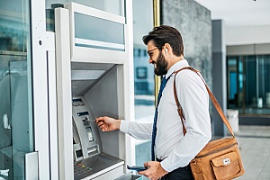 a small business owner using an ATM