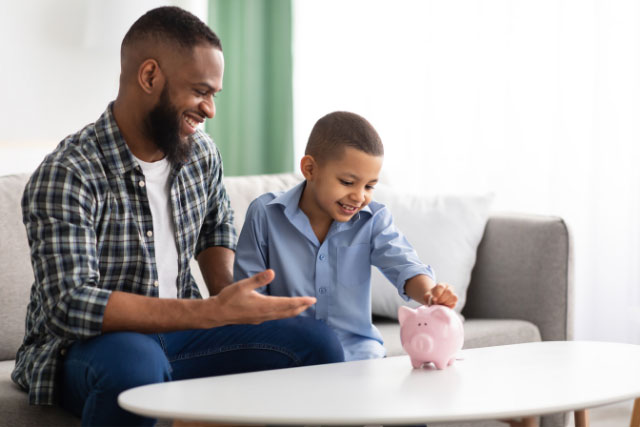 Father teaching son about personal savings accounts