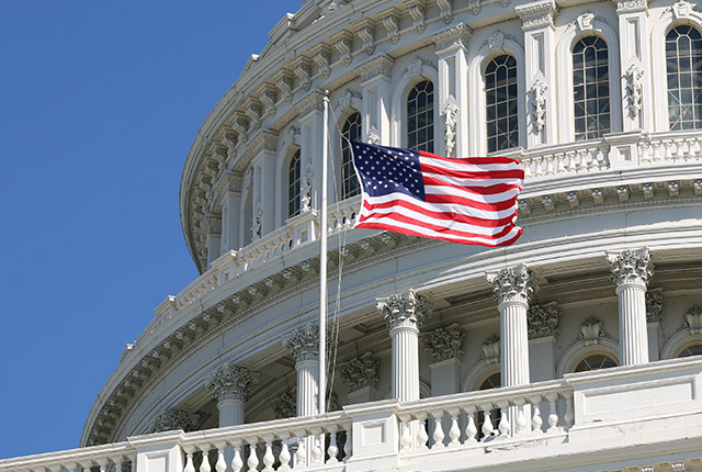 close up view of the Washington Capitol and the American flag