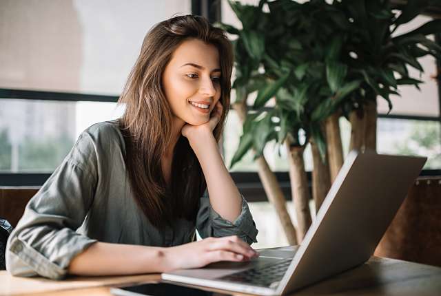 young women reviewing online banking through computer